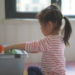 Photo teach child to pick up toys